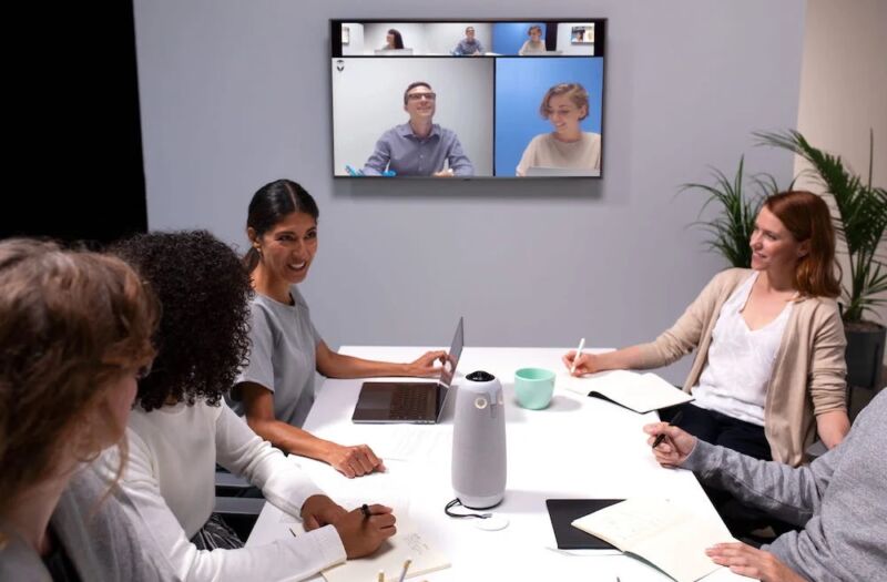 Meeting Owl Pro videoconference device being used in a hybrid meeting