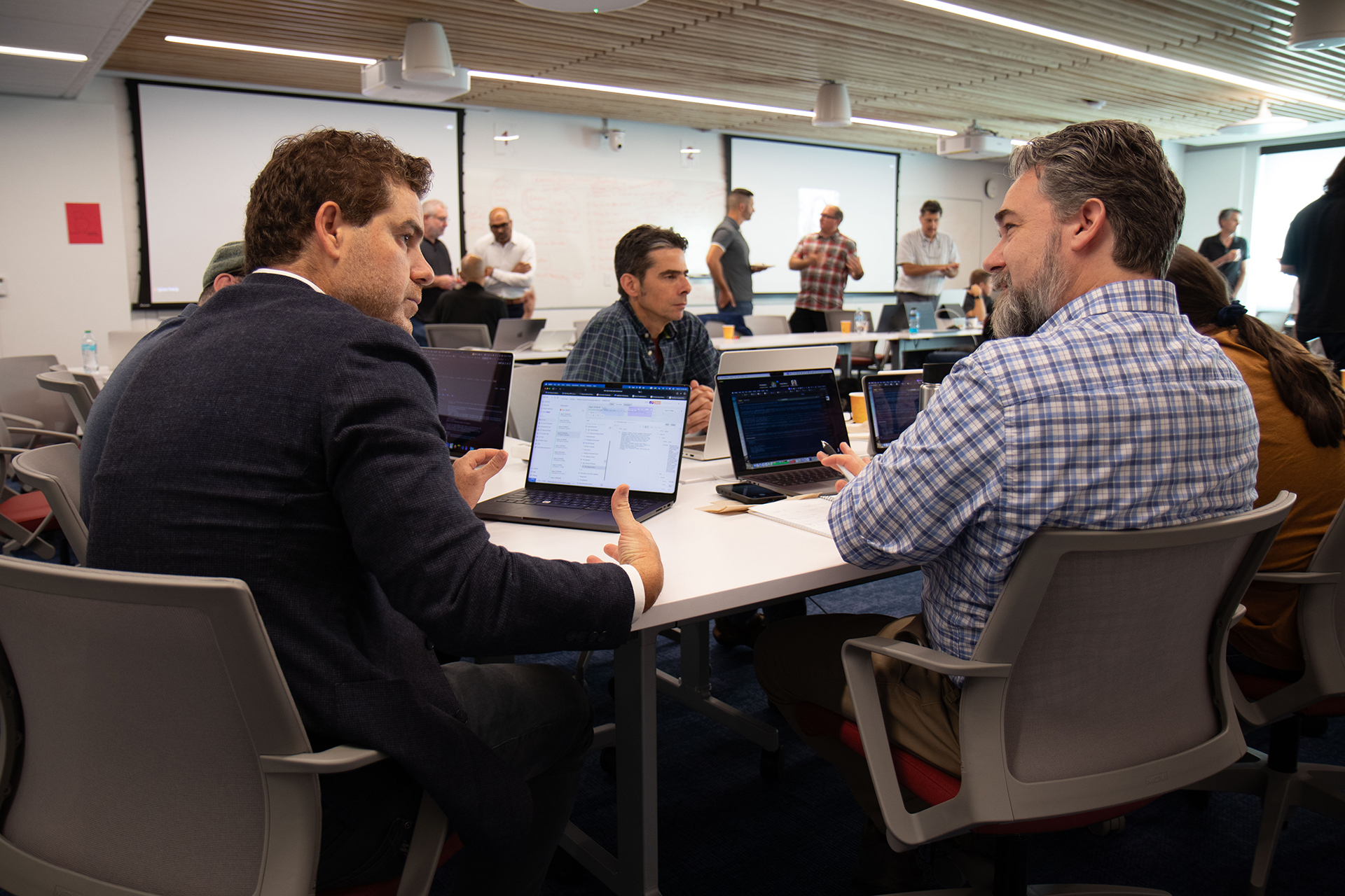 Breakout sessions in an AI workshop where small working groups discuss challenges and opportunities