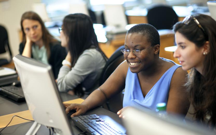 Staff collaborating at a computer