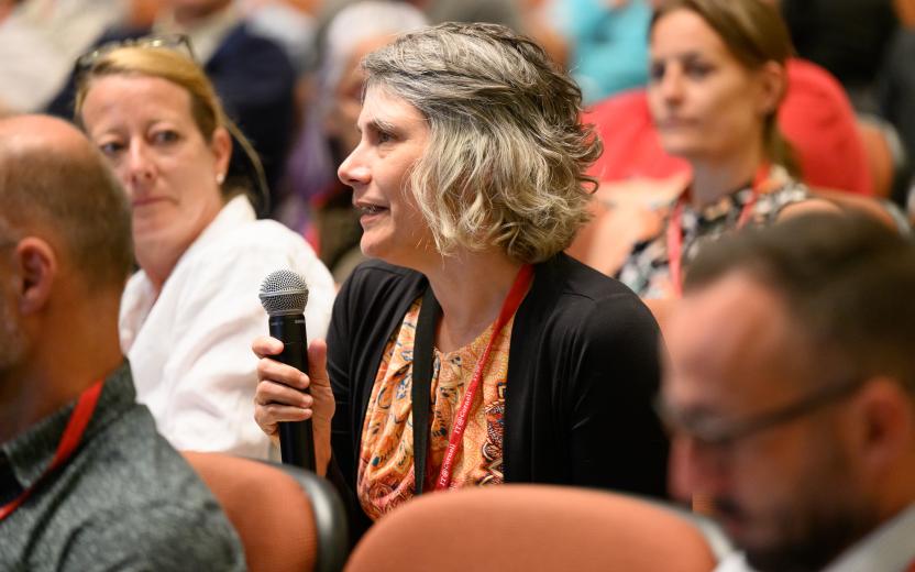 Audience member uses microphone to ask a question