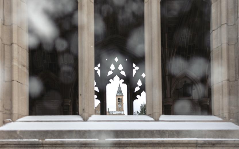 McGraw Tower shown through a snowy War Memorial.