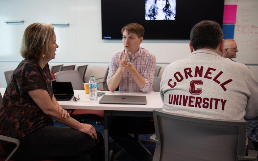 A small working group discusses an opportunity in an AI workshop.