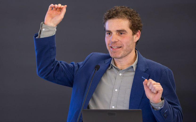 a man speaks from a podium