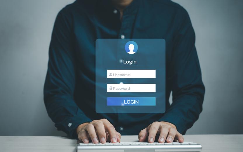 Person entering username and password into a login window.