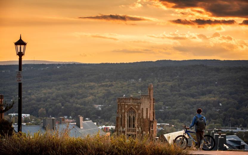 A photo of a student looking at the horizon from Libe Slope, © Cornell University, 301 College Ave, Ithaca, NY 14853; 607-255-7675; photo@cornell.edu.