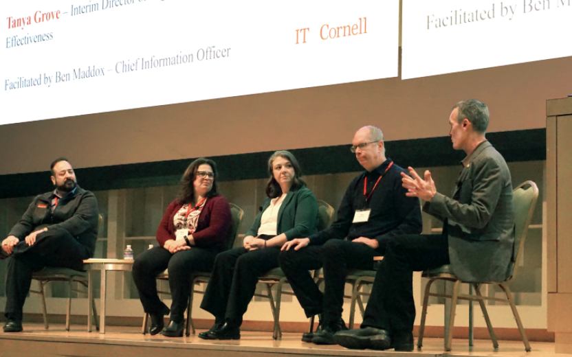 Four panelists listen to Ben Maddox, facilitator