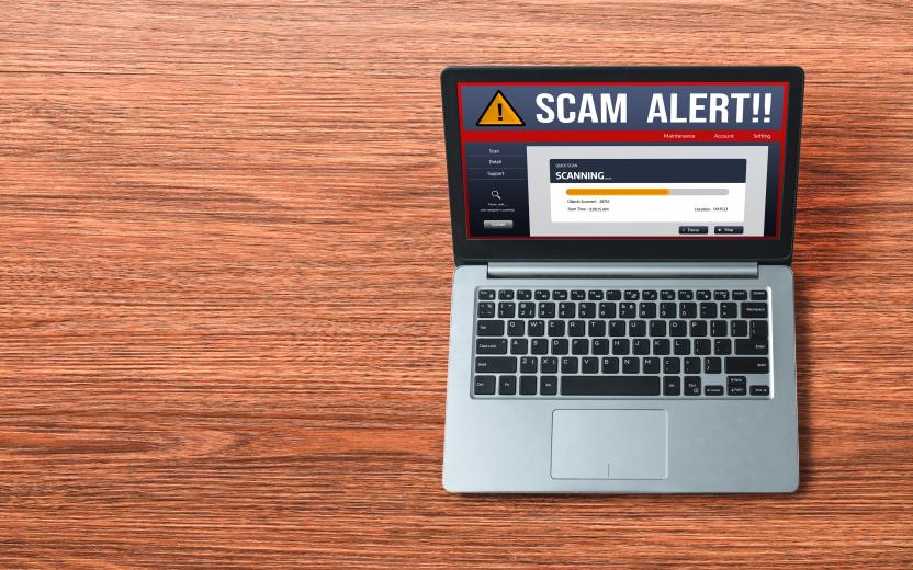 "Scam Alert" displayed on a laptop computer.