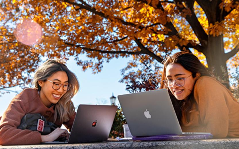 Students outdoors on laptops