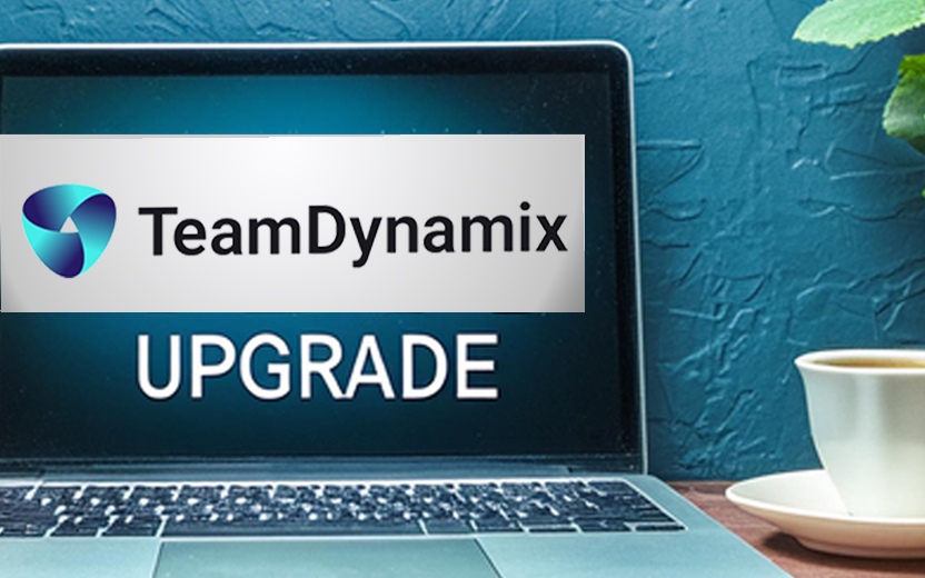 A laptop displaying the words "TeamDynamix Upgrade"
