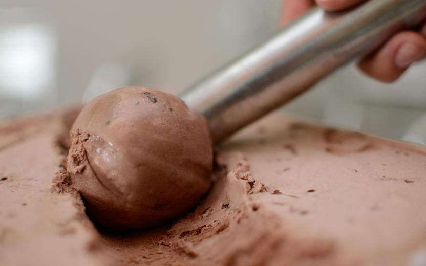 Chocolate ice cream being scooped.