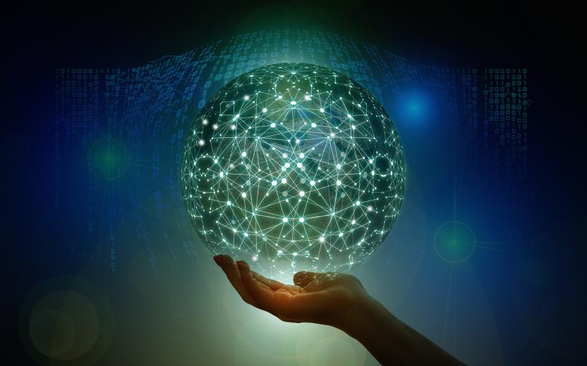A globe of network connections held up by a hand.