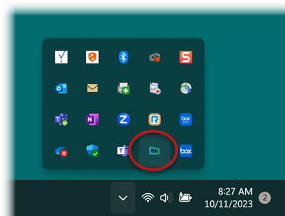 Windows 11 taskbar with system tray expanded to show CrashPlan icon as small blue folder outline.