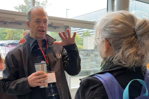 two people talk during an event coffee break