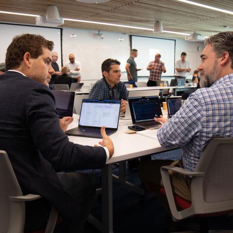 Breakout sessions in an AI workshop where small working groups discuss challenges and opportunities