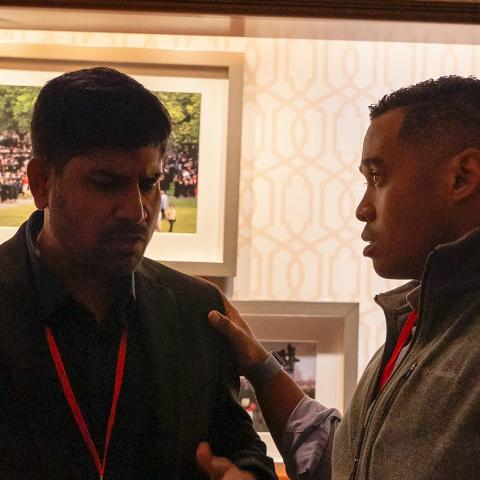 in a photo by Irfan Saloudeen, two team members discuss a difficult topic