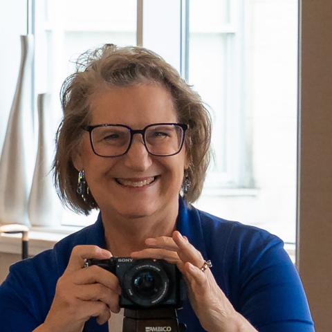 a woman taking photos at an event