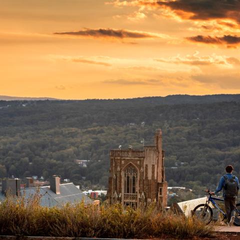 A photo of a student looking at the horizon from Libe Slope, © Cornell University, 301 College Ave, Ithaca, NY 14853; 607-255-7675; photo@cornell.edu.