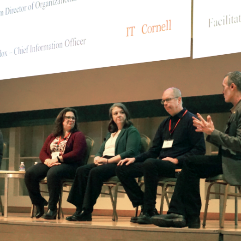 Four panelists listen to Ben Maddox, facilitator