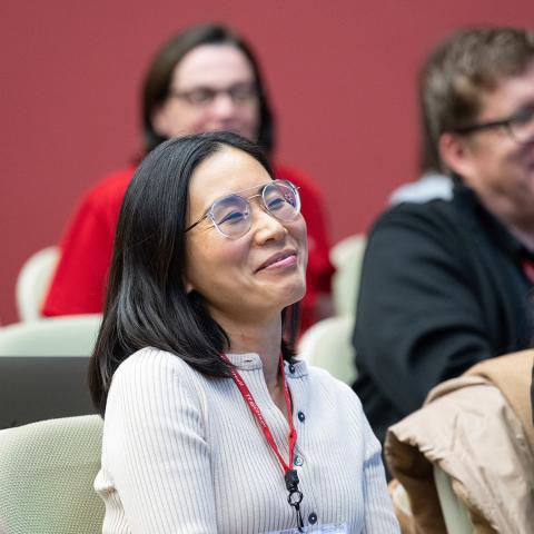 Smiling faces of an audience in a lecture hall