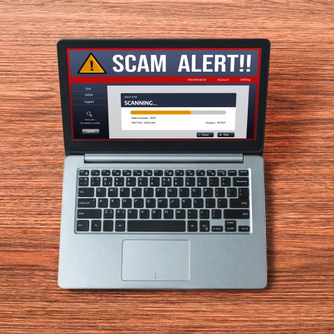 "Scam Alert" displayed on a laptop computer.