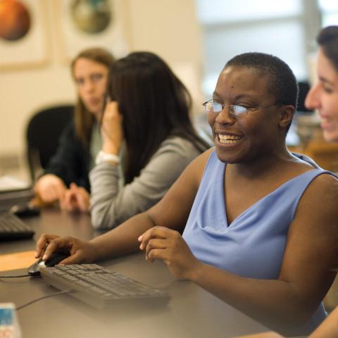People working at a computer in a Cornell library