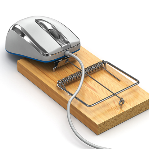 Computer mouse on top of a mousetrap