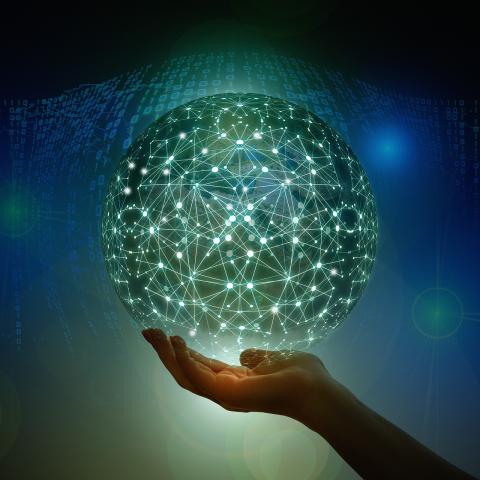 A globe of network connections held up by a hand.